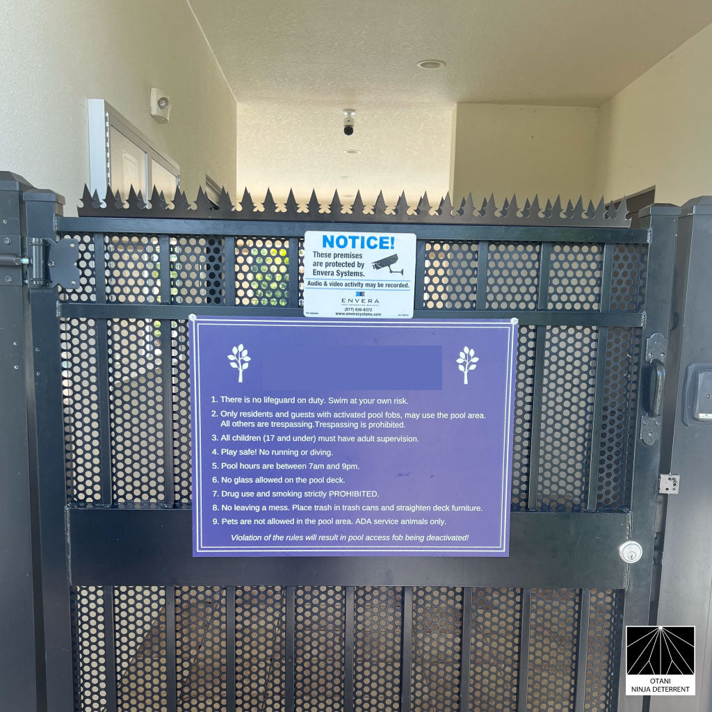 GIZAGIZA black dual heart spike installed on gate with warning sign – clean design and security in harmony