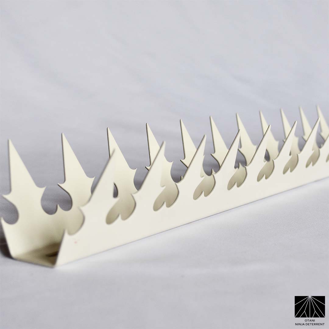 Japanese-made white dual heart security spike with sharp triangular blades for elegant perimeter and bird deterrence