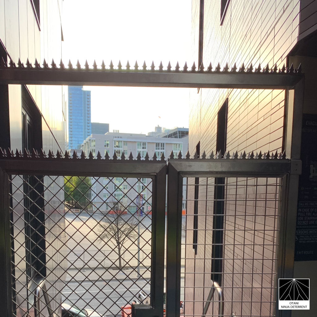 GIZAGIZA stainless dual heart spike installed on modern gate- clean design and security in harmony