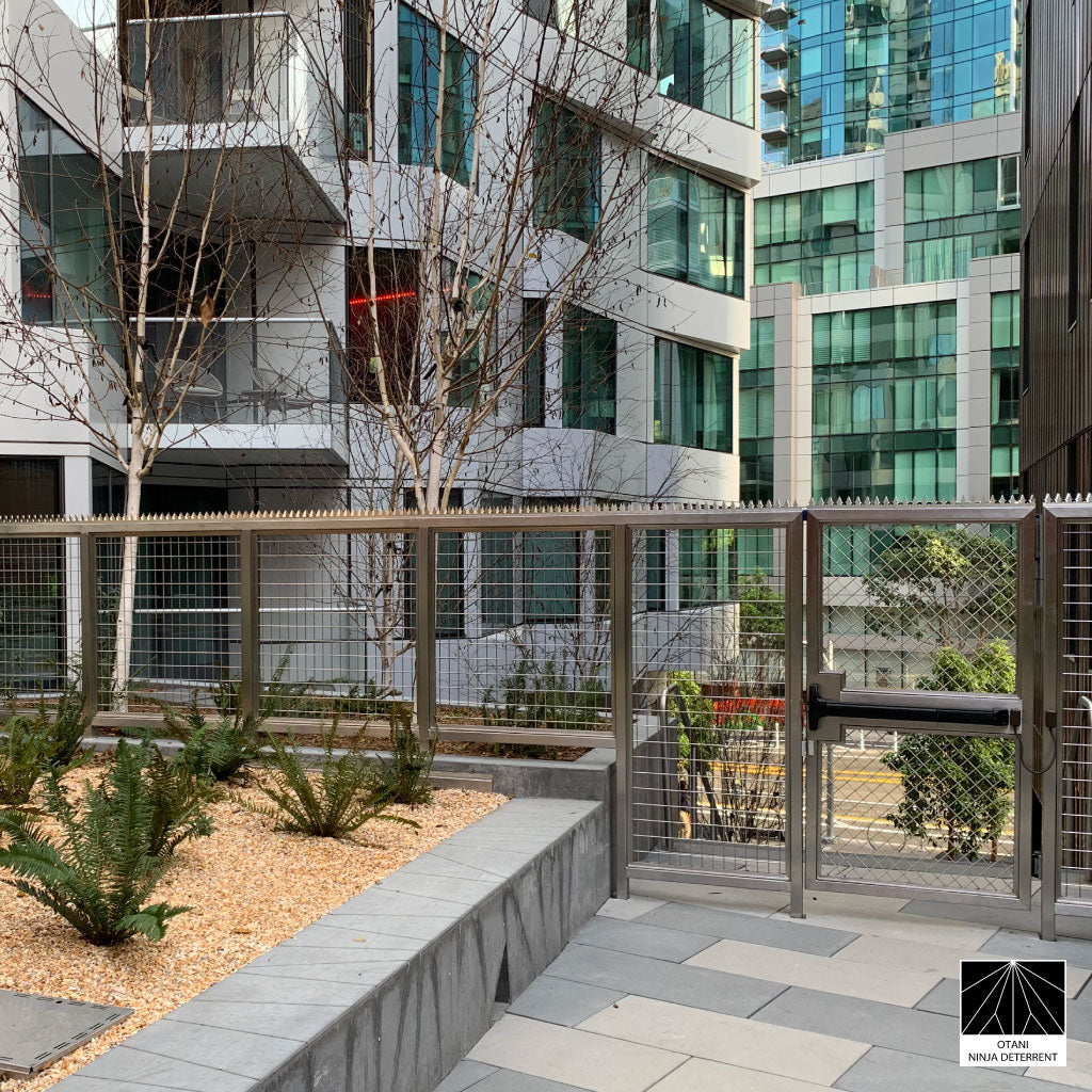 GIZAGIZA stainless dual heart spike installed on modern fence from far view- clean design and security in harmony