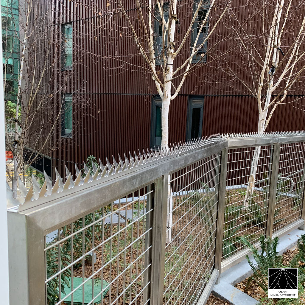 GIZAGIZA stainless dual heart spike installed on modern fence - clean design and security in harmony