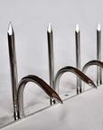 Close-up front view of double-bladed Ninja Deterrent™ in silver finish—sharp anti-intruder and anti-bird spikes