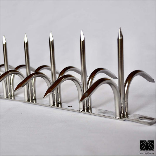 Diagonal close-up view of silver double-bladed Ninja Deterrent™—stylish and sharp anti-bird spike