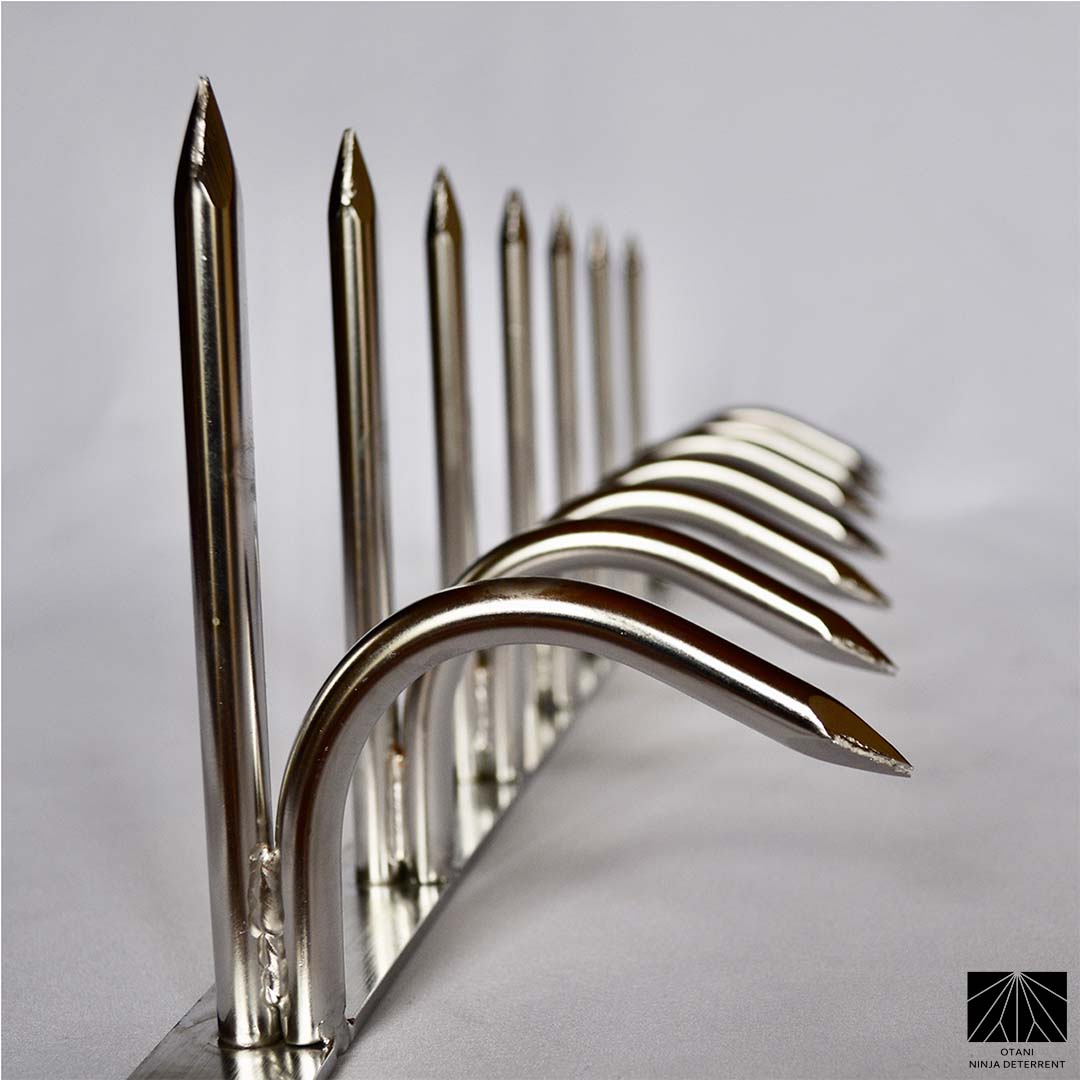 Diagonal angled view of silver double-bladed Ninja Deterrent™—designed for modern perimeter and bird control