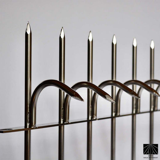 Close-up Polished stainless steel Ninja Deterrent spikes offering high-end bird control and perimeter security
